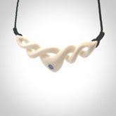 A hand carved twist pendant made from bone. This is a work of art carved by Fumio Noguchi who is renowned for his skill in bone carving. We deliver this pendant to you on a plaited black cord. Delivery with Express Courier is included in the price.